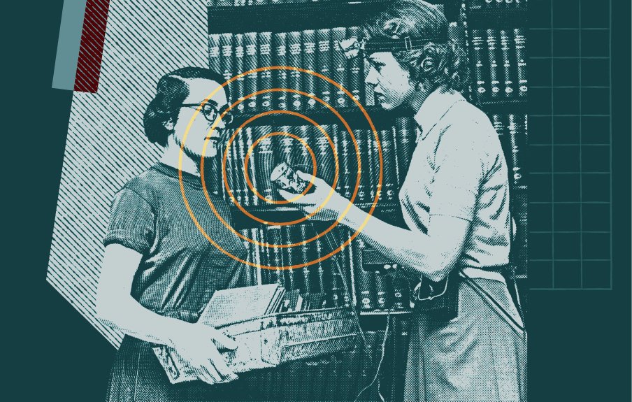 Women in library with one holding up microphone for the other to speak