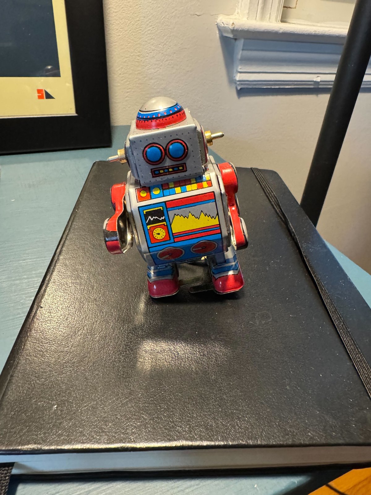 Retro Toy Robot standing on a book